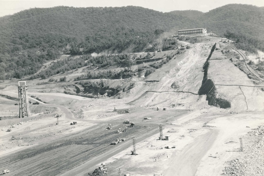 A black and white photo of an empty dam under construction