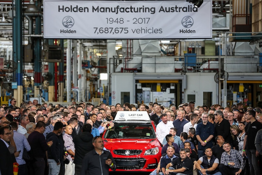 Workers at Holden's Adelaide Factory standing around a red car
