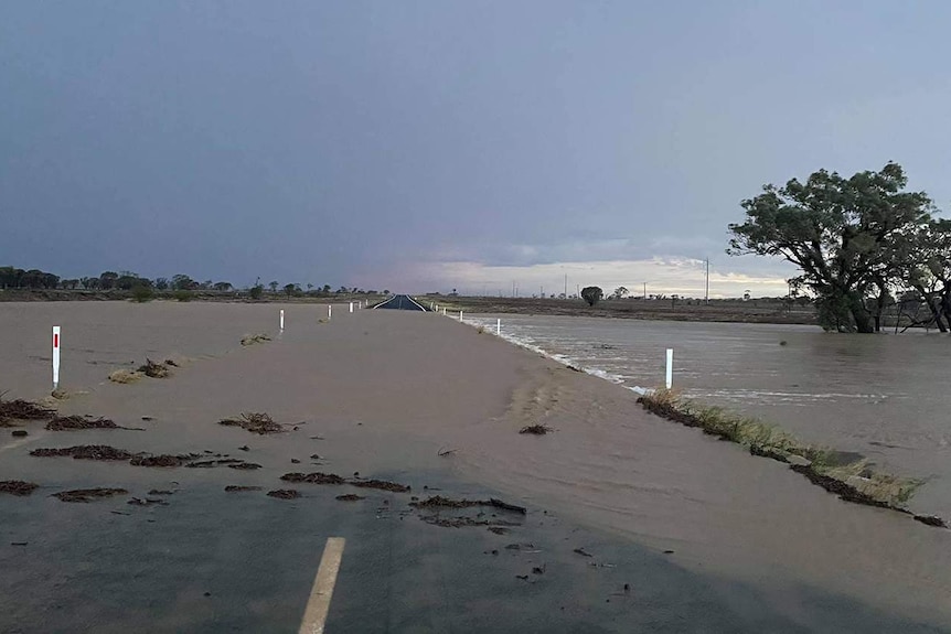 Strom water floods over an outback road