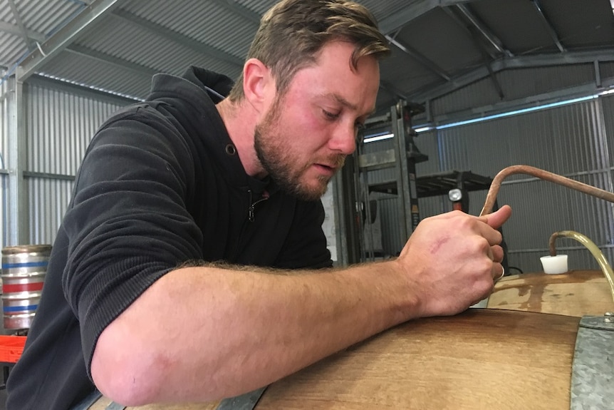 Brewer Jackson Beavis testing the brewery's upcoming 'Big Orange' beer.