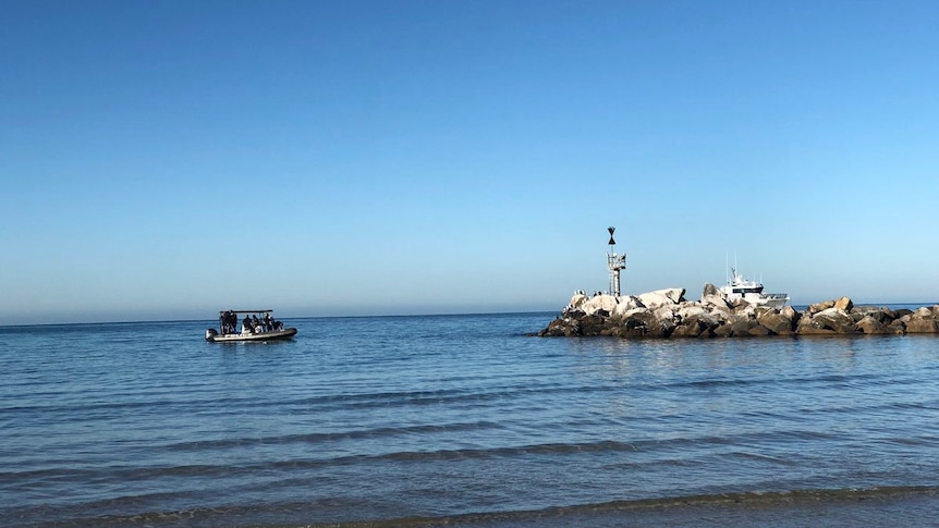 A police boat out on the water at Glenelg beach