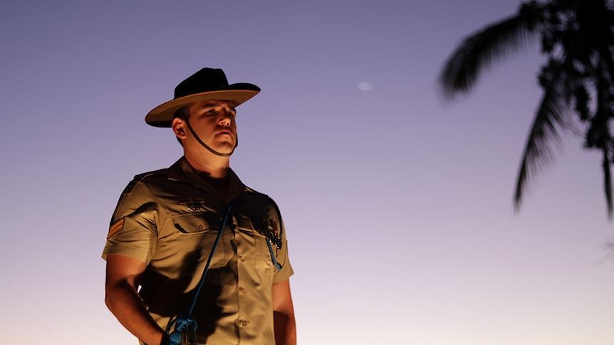 A soldier stands to attention at the dawn service in Townsville.