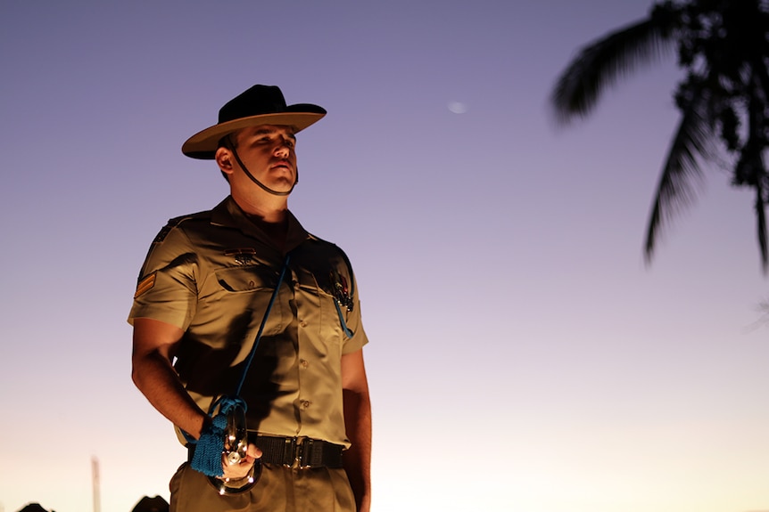 A soldier stands to attention at the dawn service in Townsville.