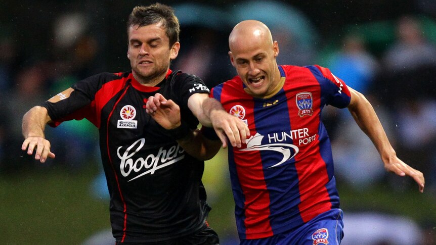Cameron Watson of Adelaide United challenges Ruben Zadkovich of the Newcastle Jets during this year's round 16 match.