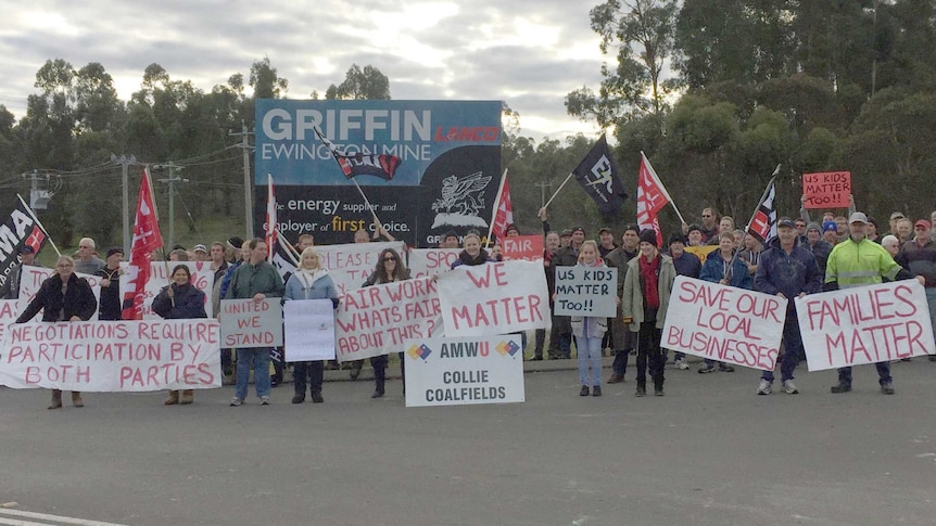 Striking workers and their supporters holding flags and placards outside the Griffin Coal mine.