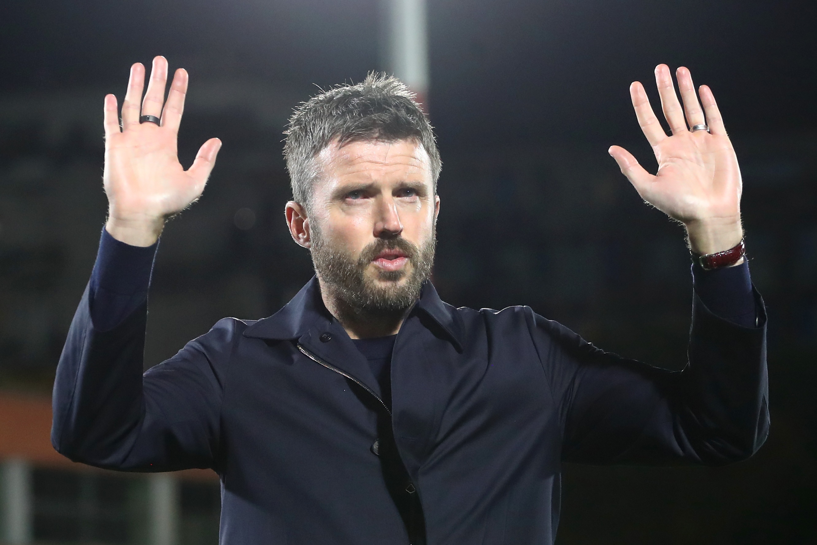 Michael Carrick raises his hands up in apology towards Man United fans