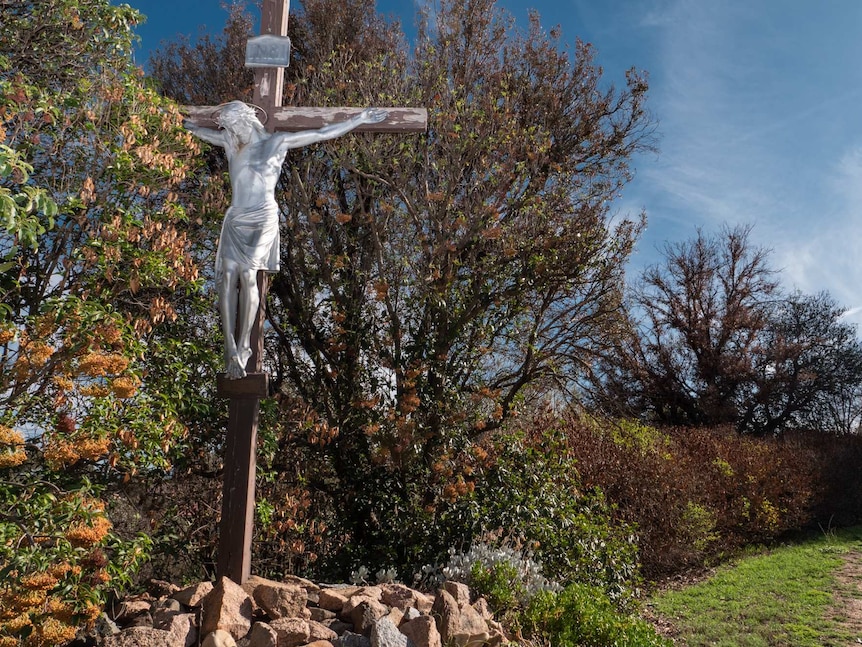 A crucifix in a garden.