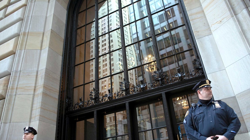 Two police officers stand outside the Federal Reserve building in New York