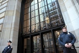 Two police officers stand outside the Federal Reserve building in New York