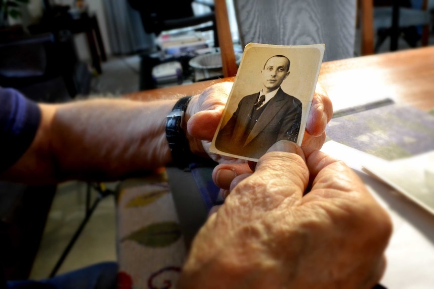 Andy Factor holds an old photo of his father, Charles.