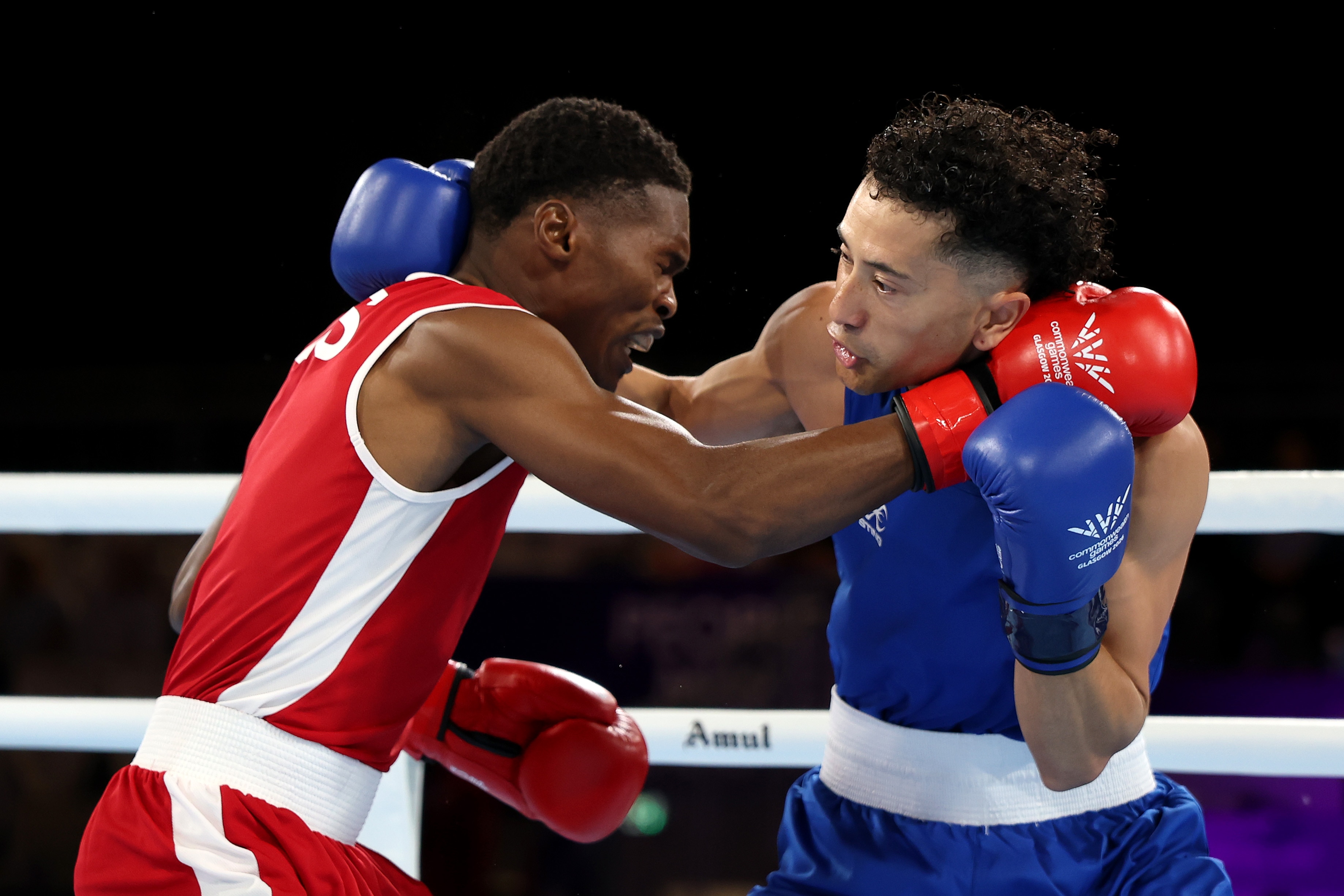 Pooana Khoahli of Team Lesotho and De Niro Pao of Team Niue during a Commonwealth Games boxing bout.