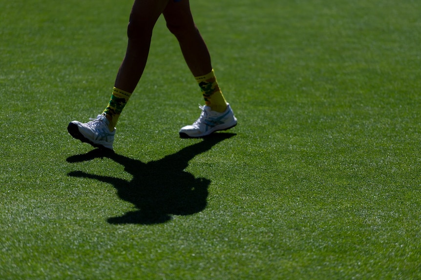 Shot of legs walking over grass on outfield of the Adelaide Oval.