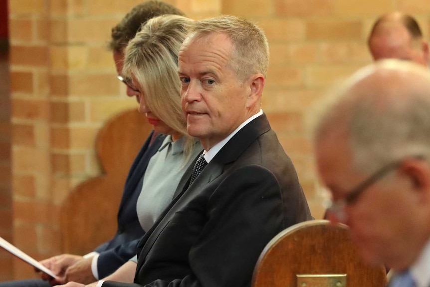 Bill Shorten glances at Scott Morrison in church