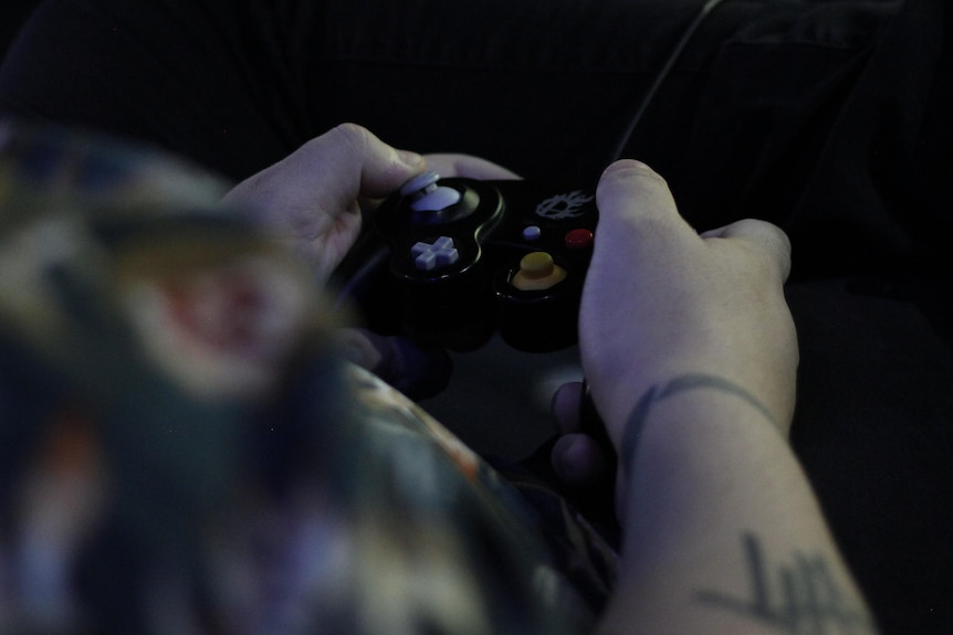 A hand on a video game controller.