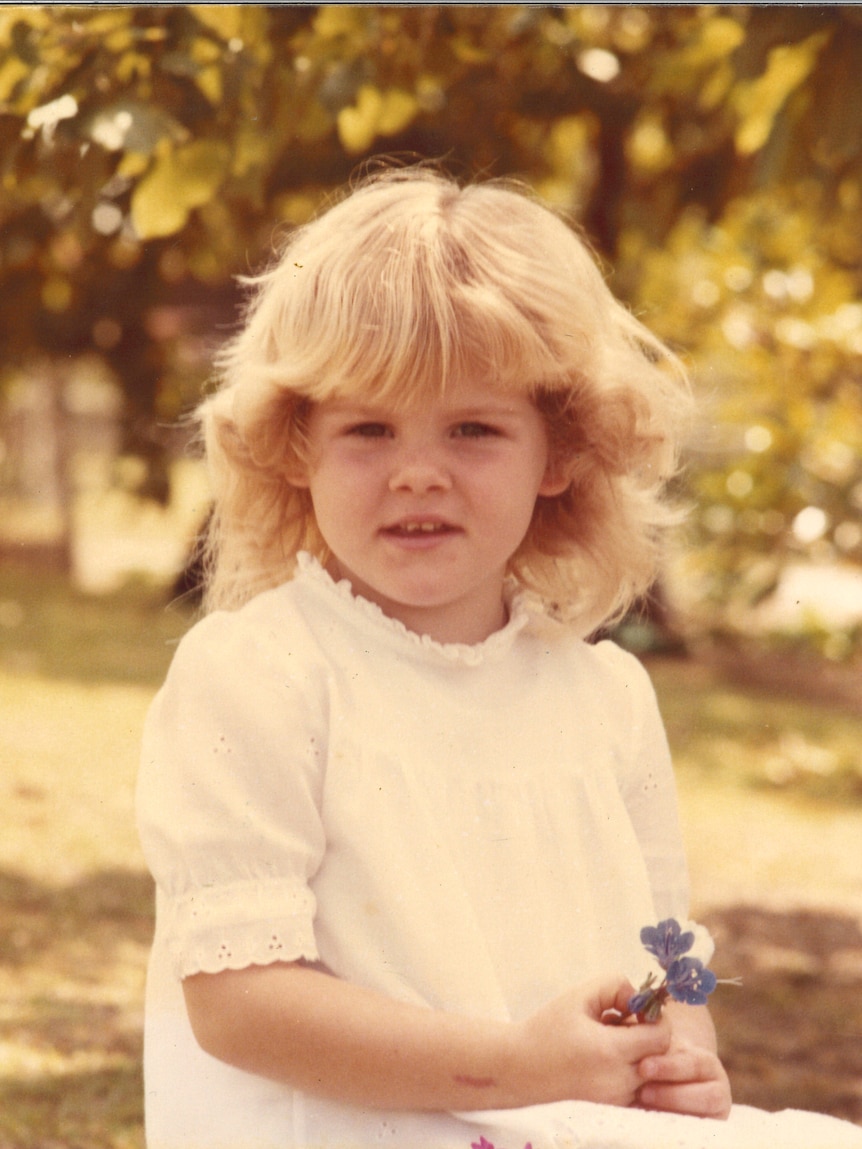 An old photo of a young girl aged four. 