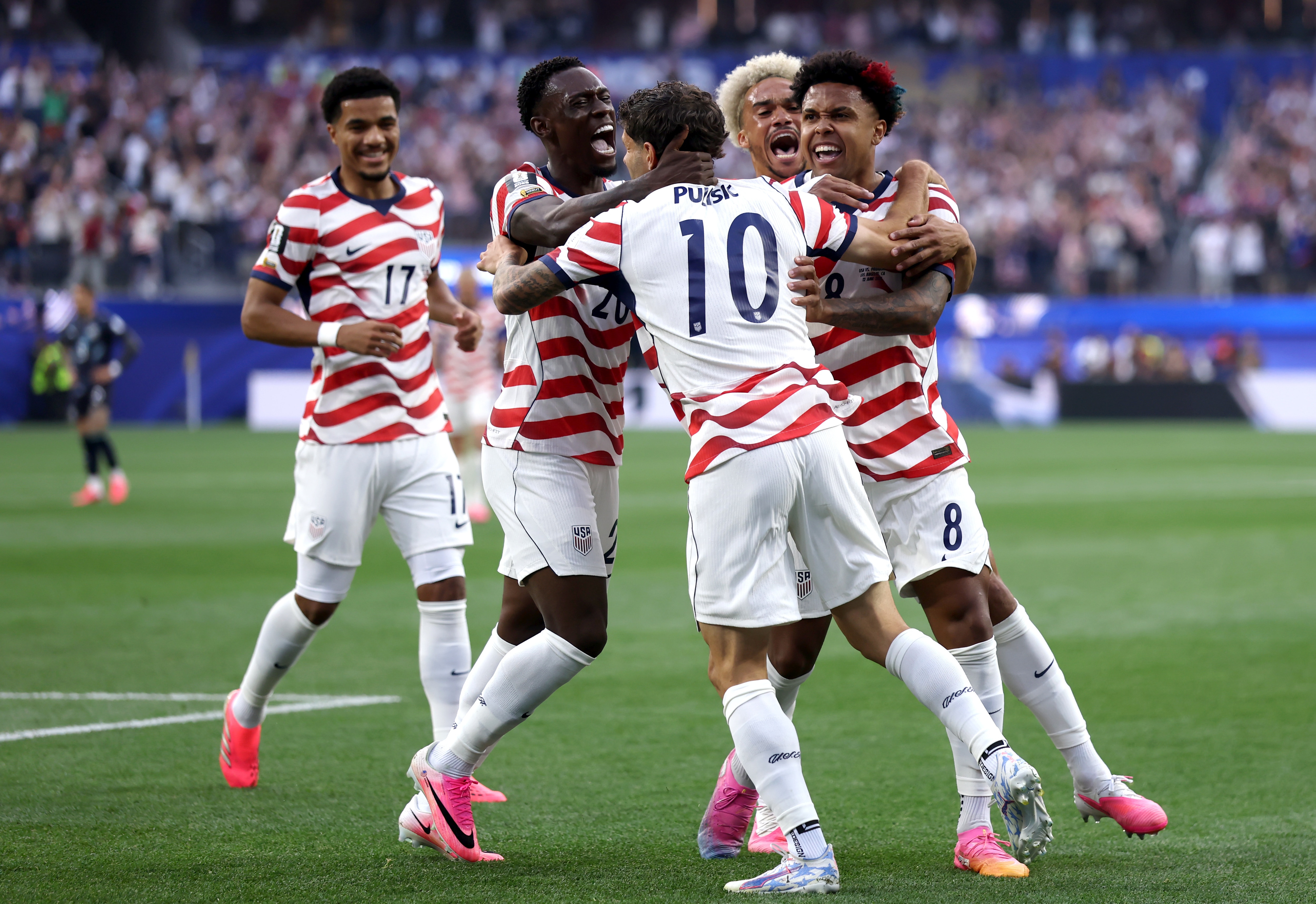 US players celebrate the opening goal against Paraguay together