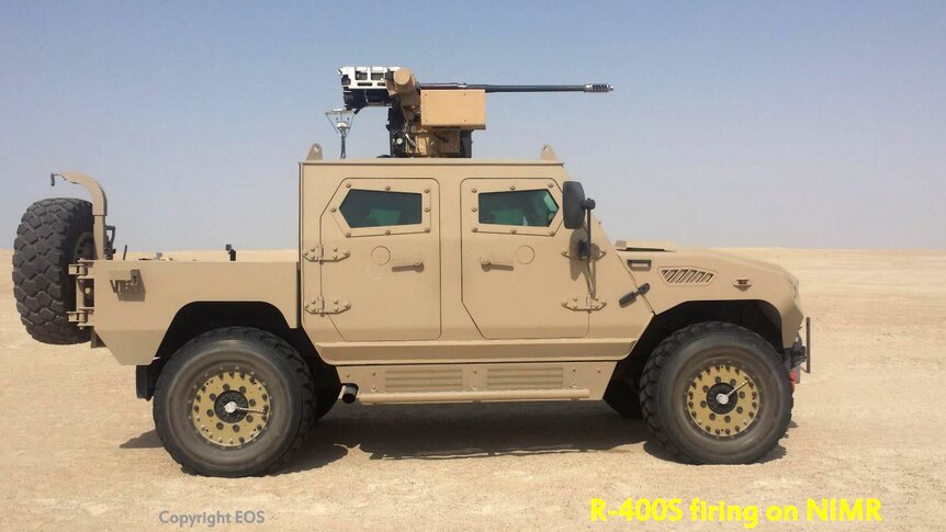 An armoured military vehicle with a large gun mounted on top, in the desert.