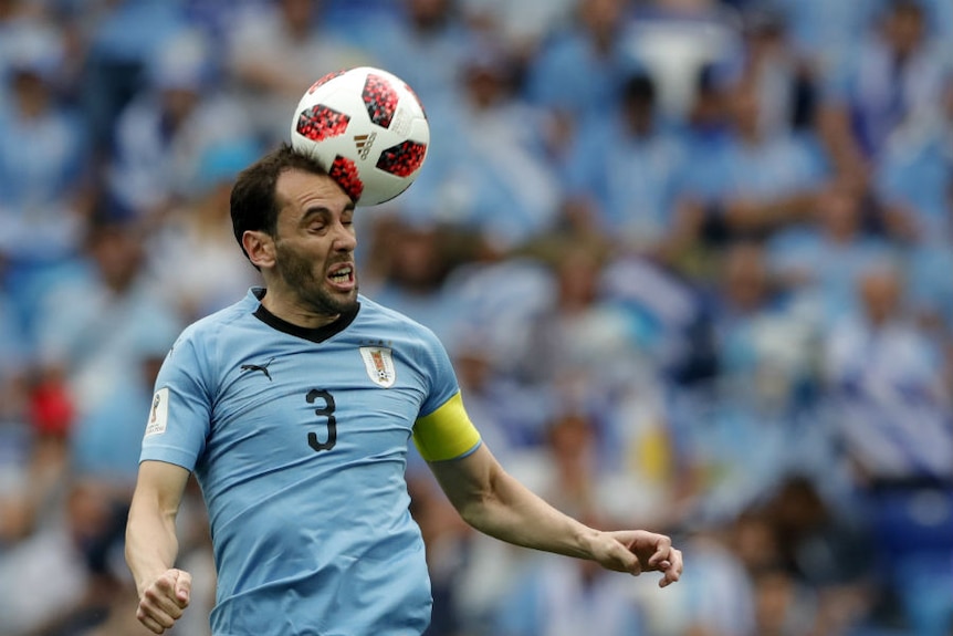 Uruguay's Diego Godin heads the ball