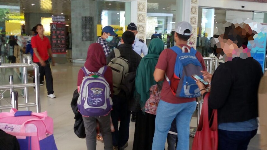 The family is escorted by anti-terror police