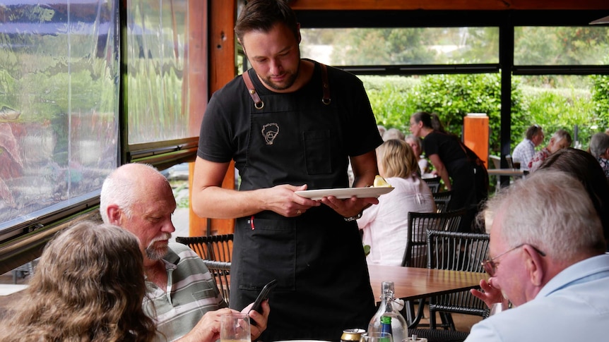 waiter serving a table of people