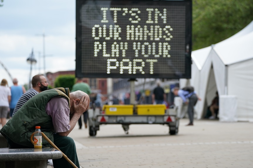 Man holding head in hands