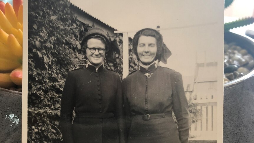 Historic photo of Peggy Muller (right) dressed in a Salvation Army uniform, standing with a friend, date unknown