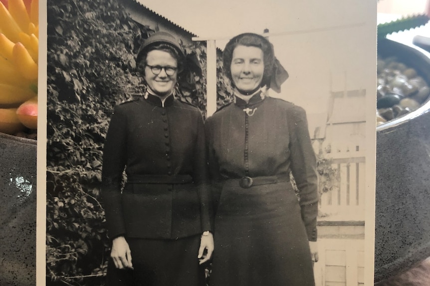 Historic photo of Peggy Muller (right) dressed in a Salvation Army uniform, standing with a friend, date unknown
