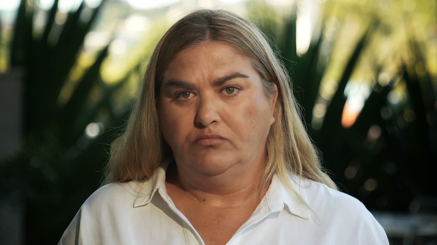 An Indigenous woman with blonde hair looking at the camera