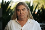 An Indigenous woman with blonde hair looking at the camera