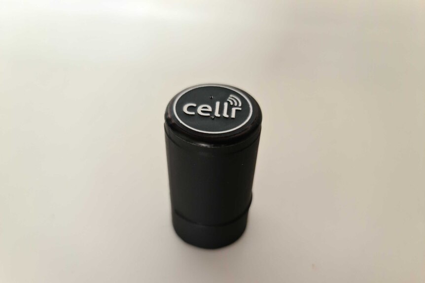 A black wine bottle top with the word Cellr in white on top.