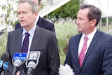 Bill Shorten, left, stands in front of a row of microphones next to Mark McGowan, right, with trees in the background.