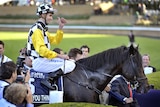 Steve Arnold celebrates in the mounting yard after steering So You Think to victory
