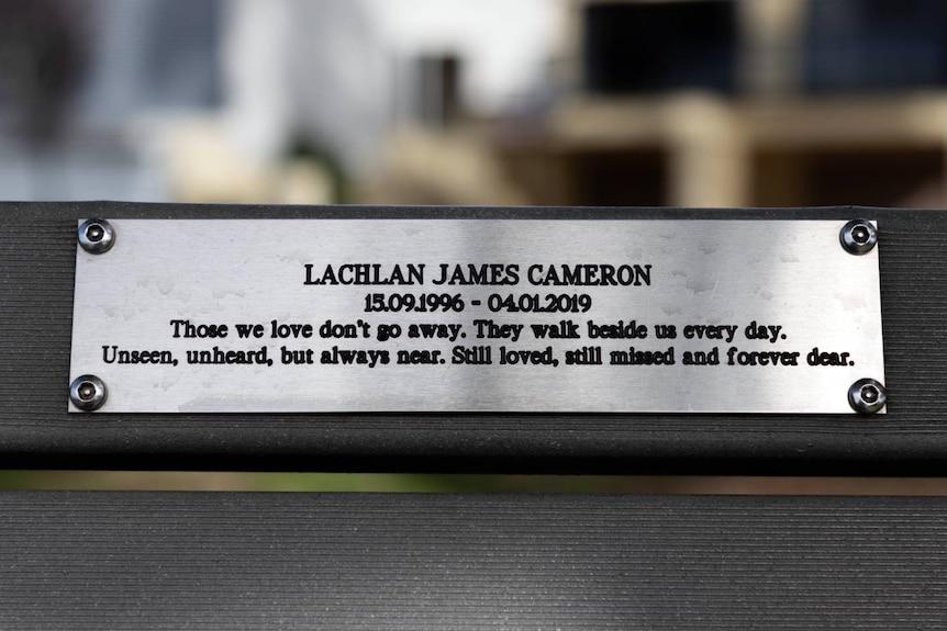 A plaque on a park bench.