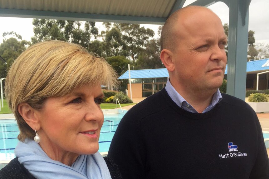 Julie Bishop stands with Matt O'Sullivan with a swimming pool in the background.