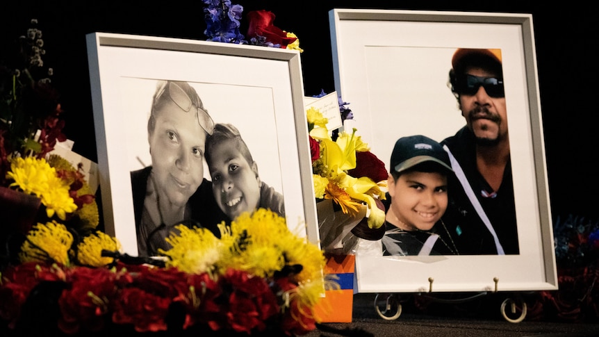 Family pictures displayed on a table surrounded by flowers