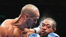 Anthony Mundine delivers a blow to Rico Chong Nee in their super middleweight bout in Perth.