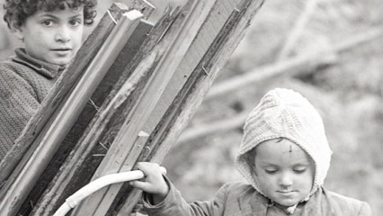 Two children collect firewood on Napier Street, Fitzroy.