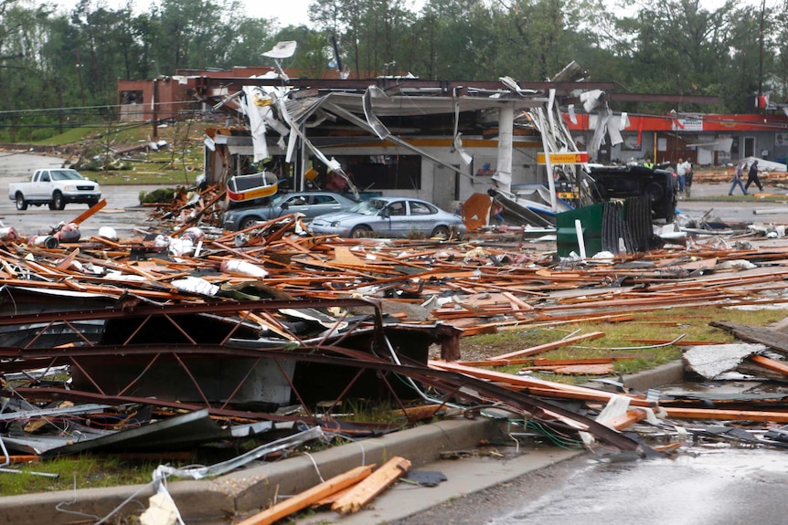 Debris is scattered along North Gloster Street after a tornado tore through Tupelo, Mississippi.
