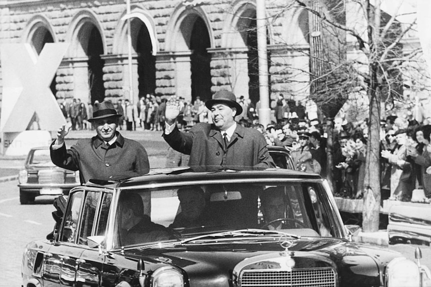 Bulgarian Prime Minister Todor Zhivkov waving from the back of a car