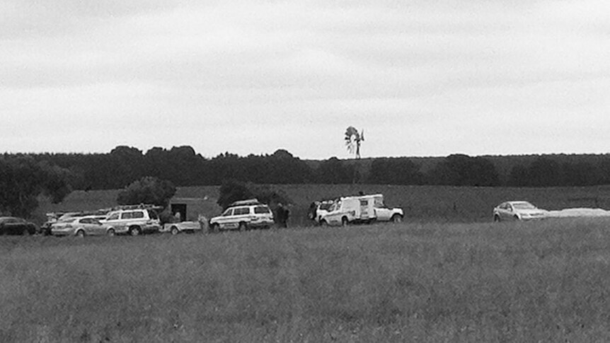 Emergency vehicles in a field.