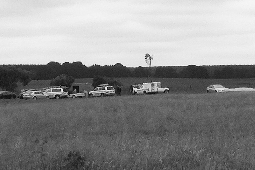 Emergency vehicles in a field.