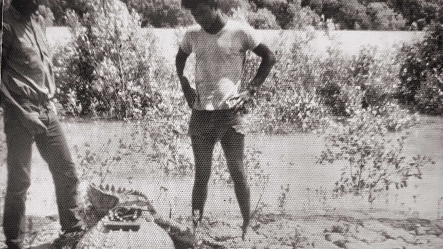 Peter Pangquee pictured centre frame with a captured crocodile.