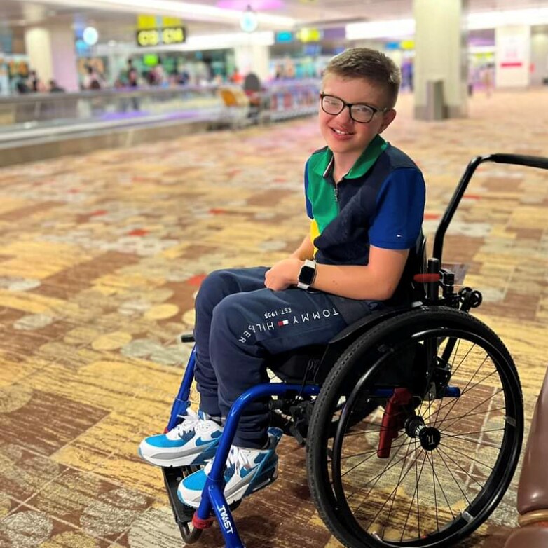 boy seated in wheelchair at airport