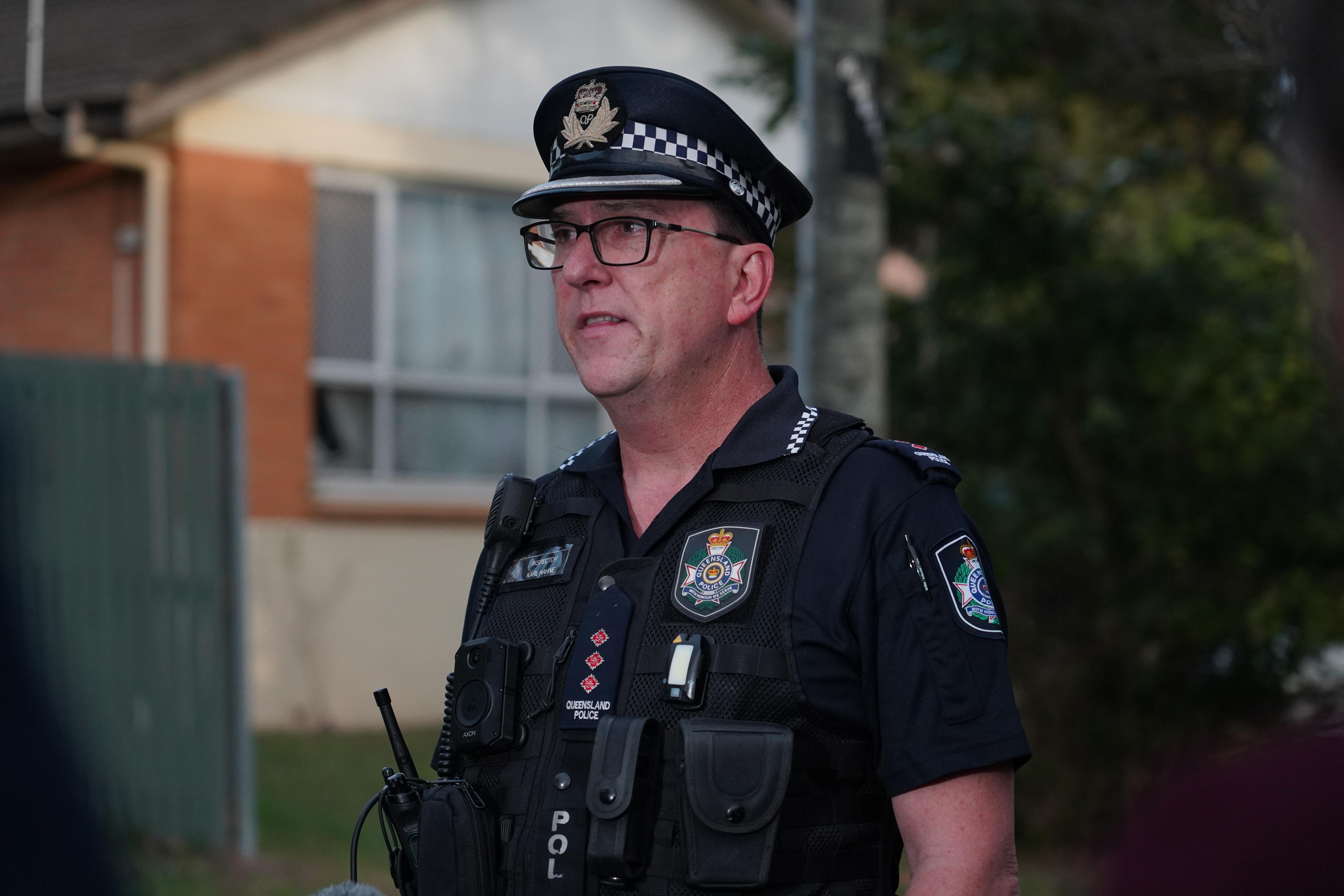 A man in a Queensland Police uniform wearing glasses.