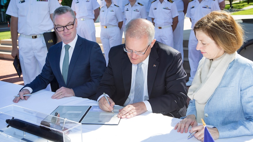 Politicians Chris Pyne and Scott Morrison sign an agreement