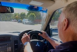 an elderly driver behind the wheel