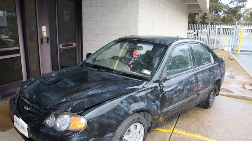 The 2003 black Kia Spectra sedan believed to be involved in Hughes murder