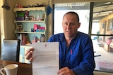 Farmer Tim Paulet holds his letter from Prince Charles.