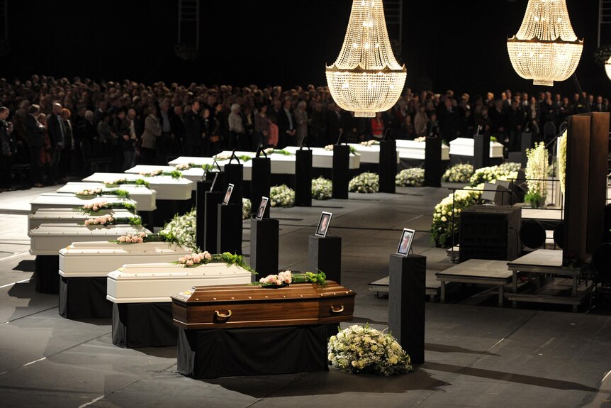 Coffins of some victims of Swiss bus crash at a ceremony in Lommel, Belgium.