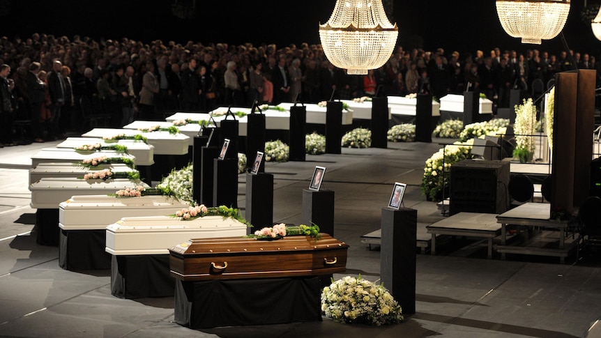 Coffins of some victims of Swiss bus crash at a ceremony in Lommel, Belgium.